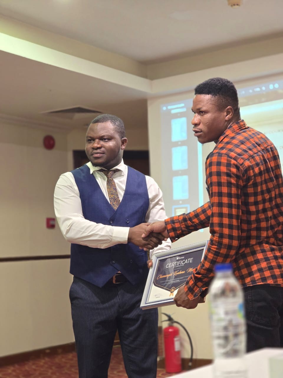 Mr Moses is receiving his Mindsspark Certificate.